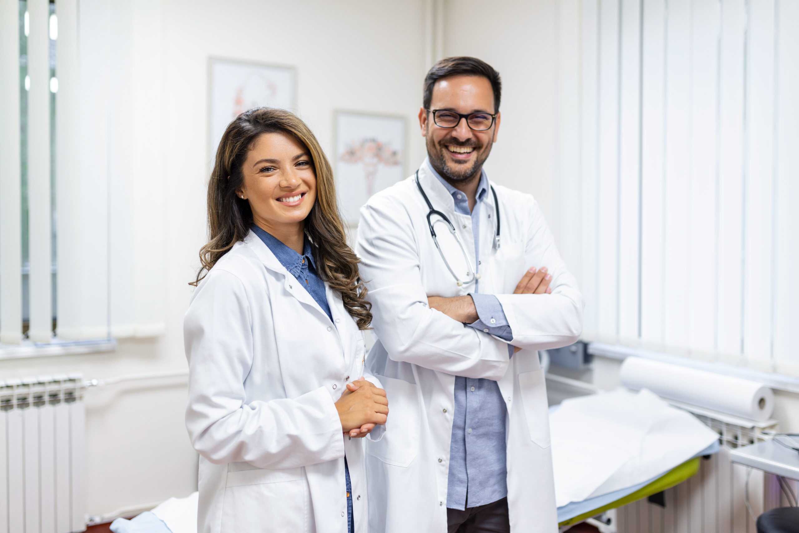 smiling young doctors standing together portrait medical staff inside modern hospital